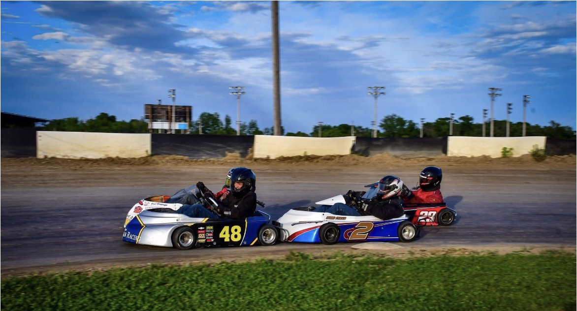 children racing around race track