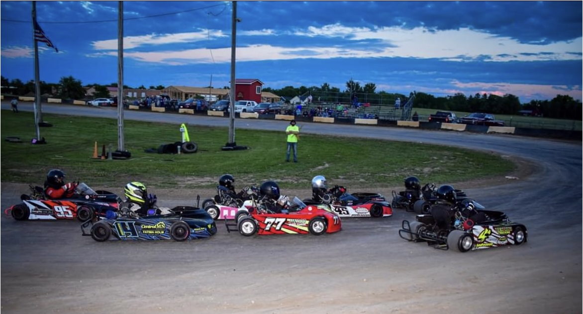 children racing around race track