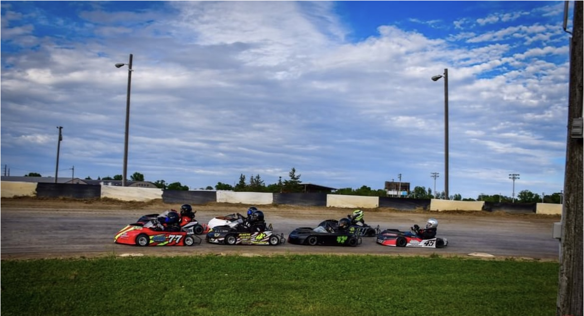 people in go karts racing close together
