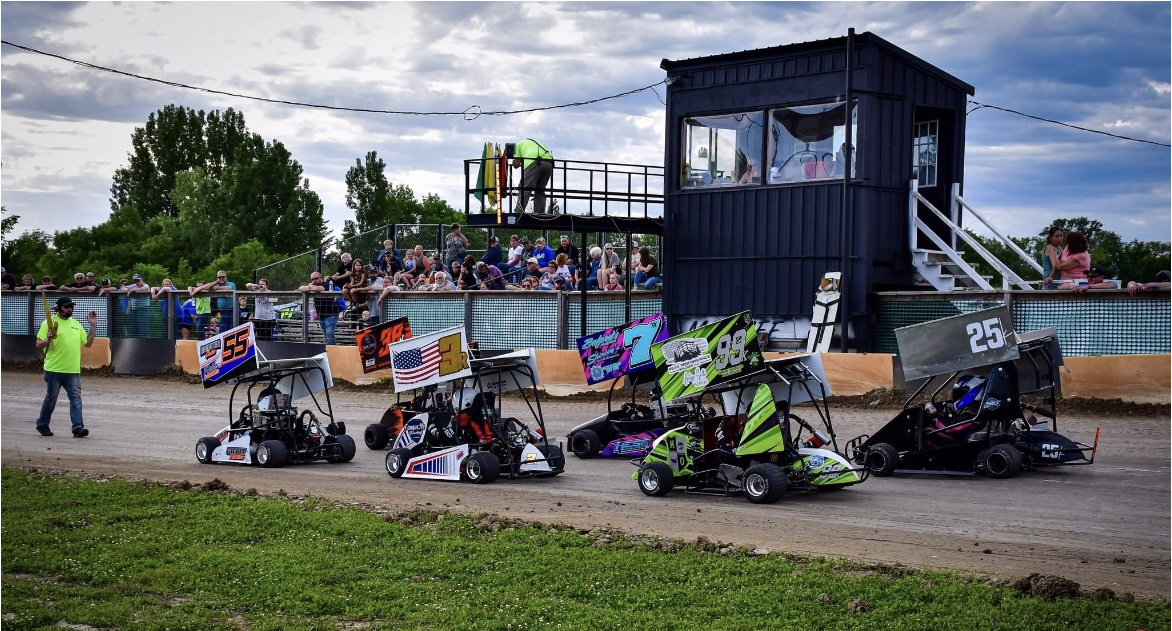 people in go karts racing close together