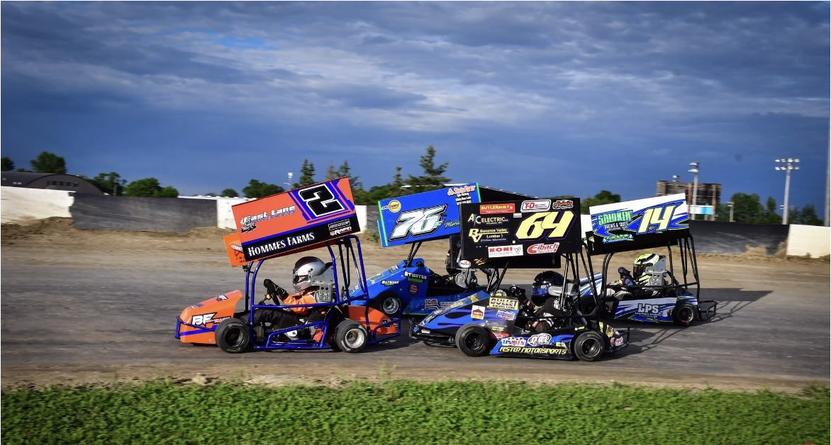 people in go karts racing close together