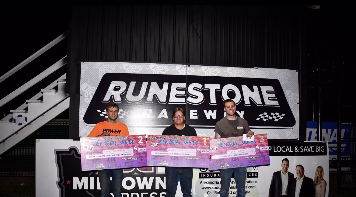 podium of winners with their check prizes
